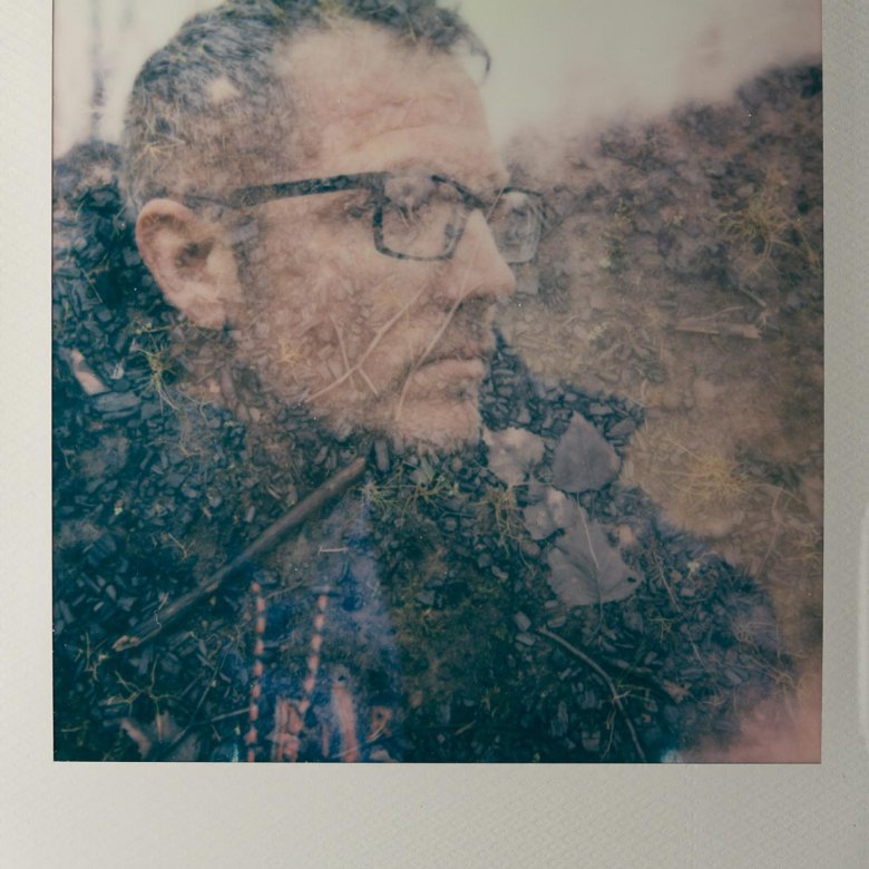 Polaroid of a man wearing glasses