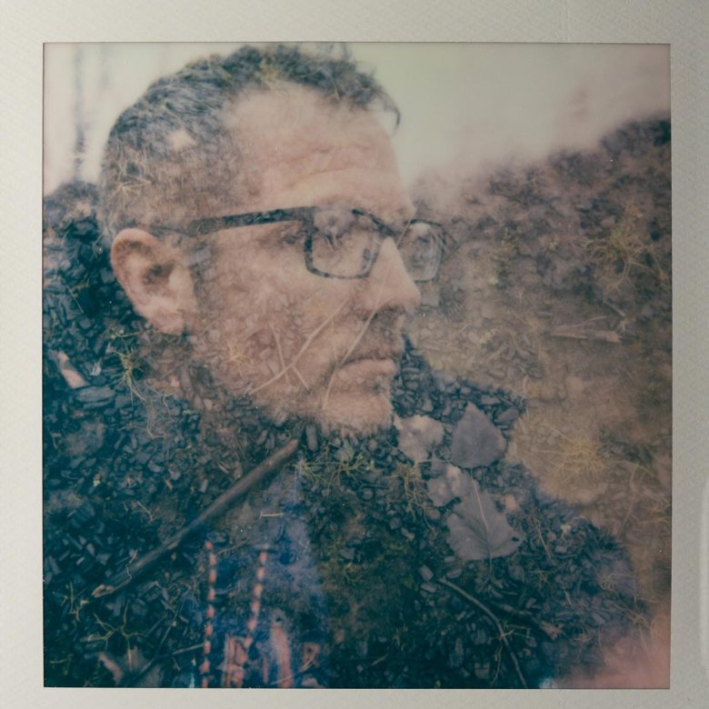 Polaroid of a man wearing glasses