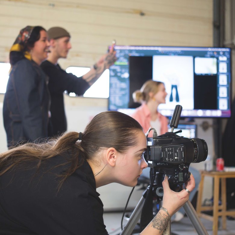 Fashion photography student taking photo in studio