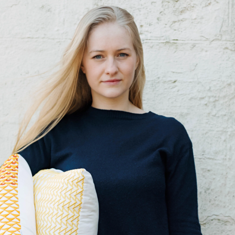 A woman holding some cushions