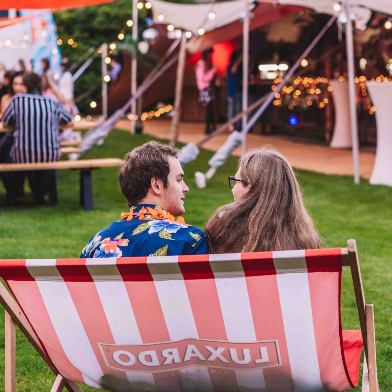 Two students sat on an oversized deckchair