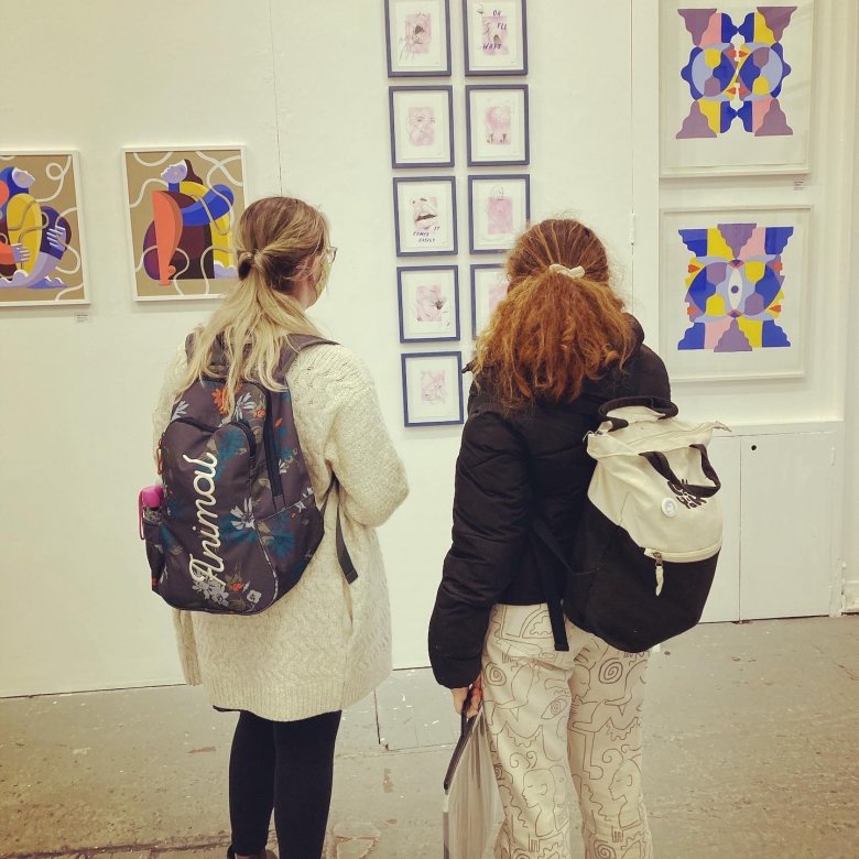 Students admire work at an illustration exhibition in Bristol 