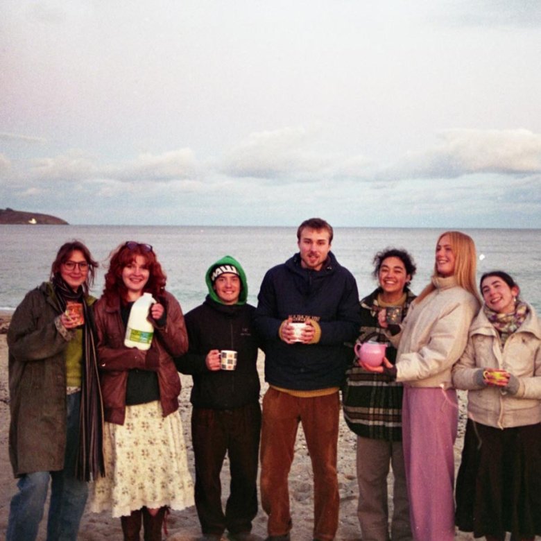 Falmouth University students on Gylly Beach at dusk
