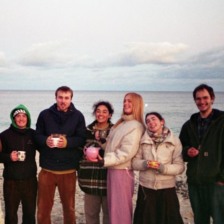 Falmouth University students on Gylly Beach at dusk