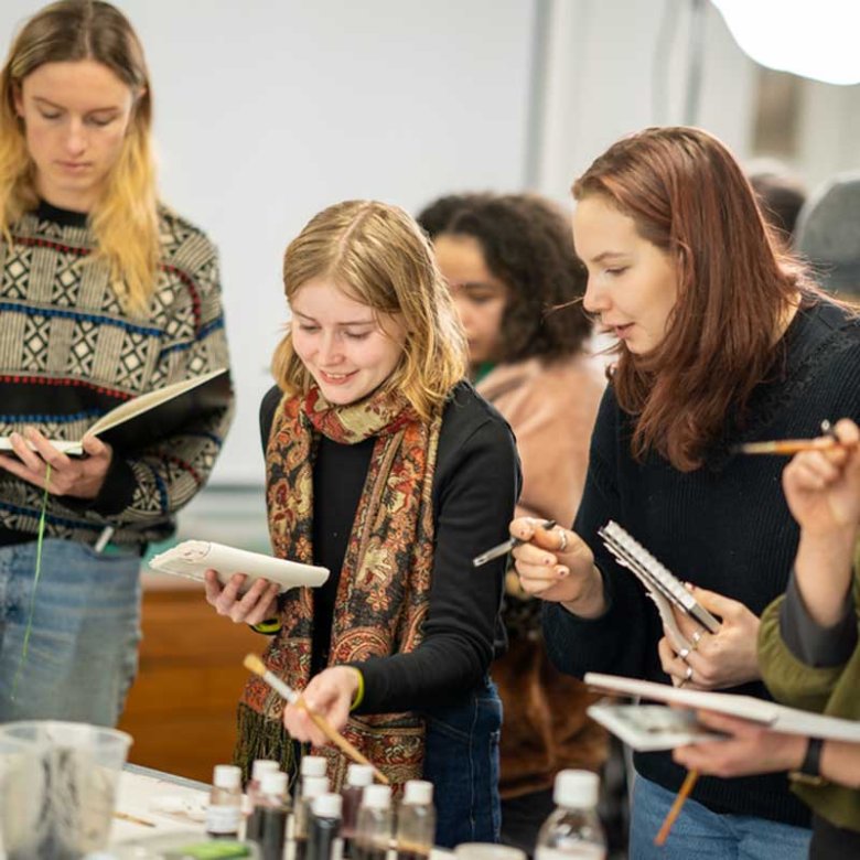 Students painting in a workshop at Falmouth Illustration Festival 