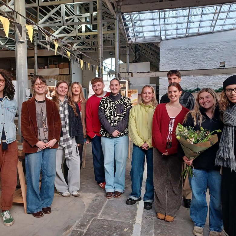 A group of Interior Architecture students and lecturer in a building interior