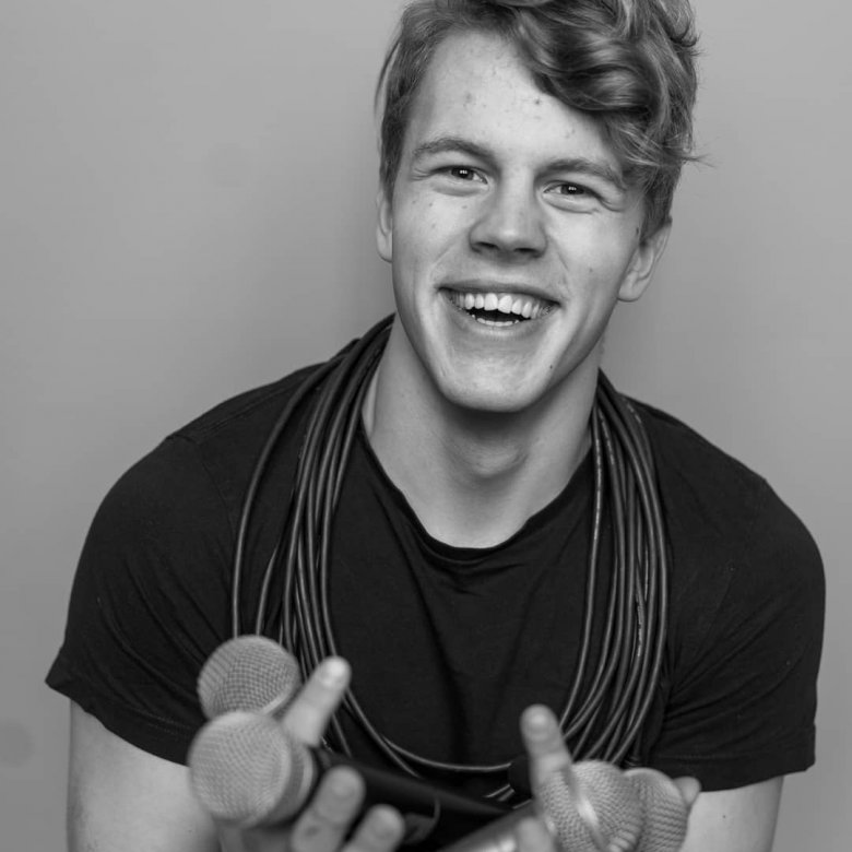 A man holding microphones in black and white