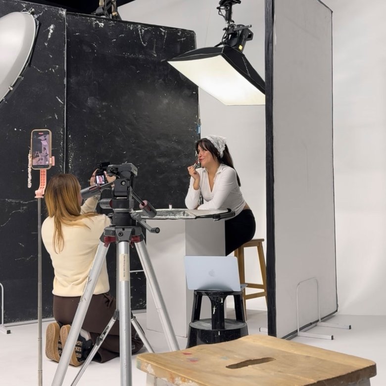 A Falmouth University student photographing another student in the studio