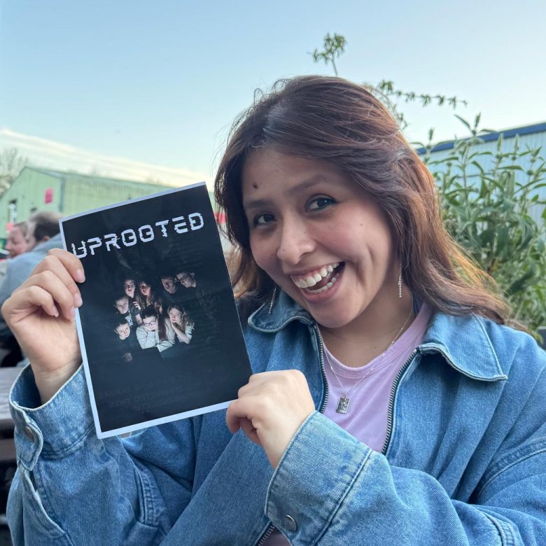 A Theatre & Performance student holding up a poster
