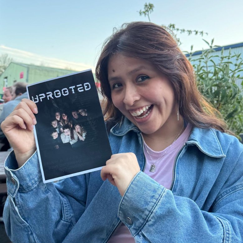 A Theatre & Performance student holding up a poster