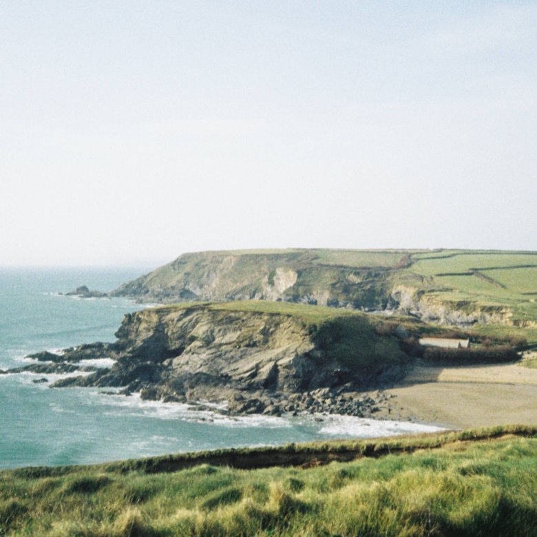 Landscape shot of the Cornish coast - the ocean and cliffs are visible