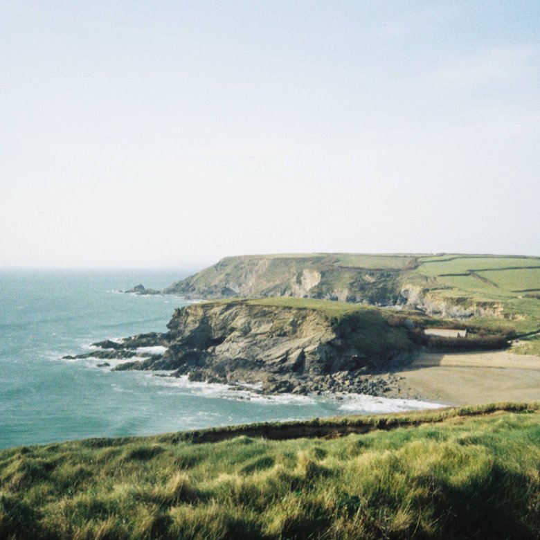Landscape shot of the Cornish coast - the ocean and cliffs are visible
