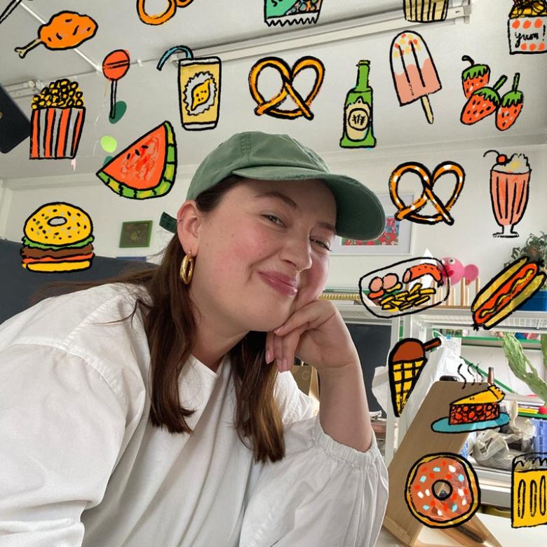 A woman wearing a cap and smiling