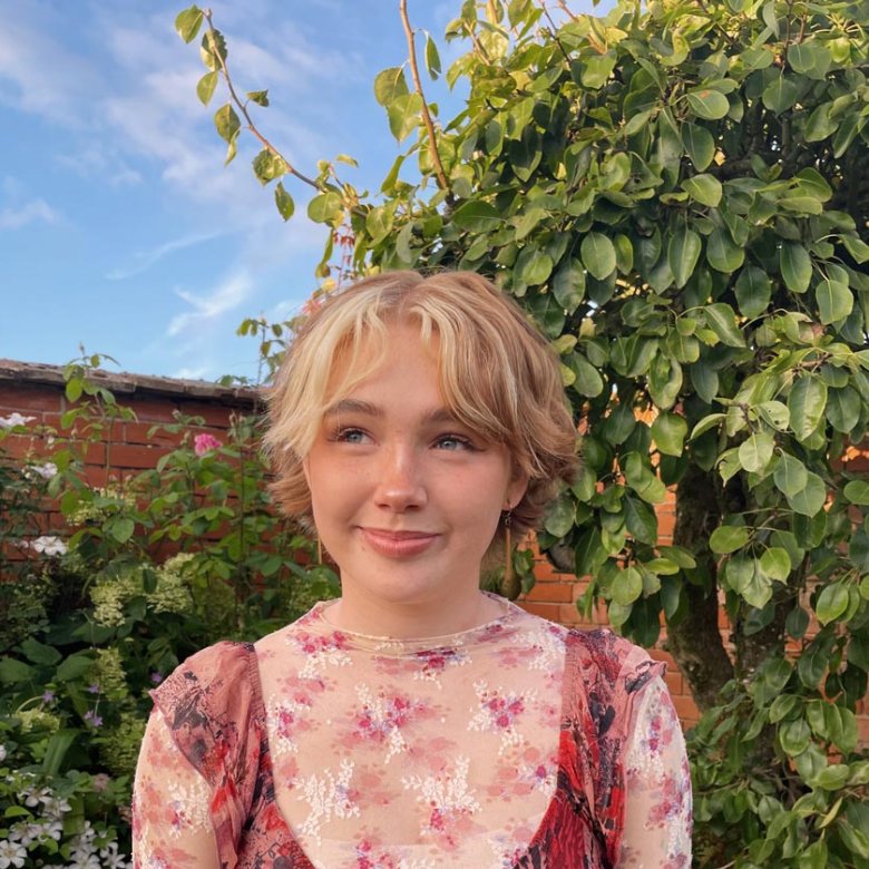 Photograph of Falmouth graduate Niamh Shergold outside with blue sky