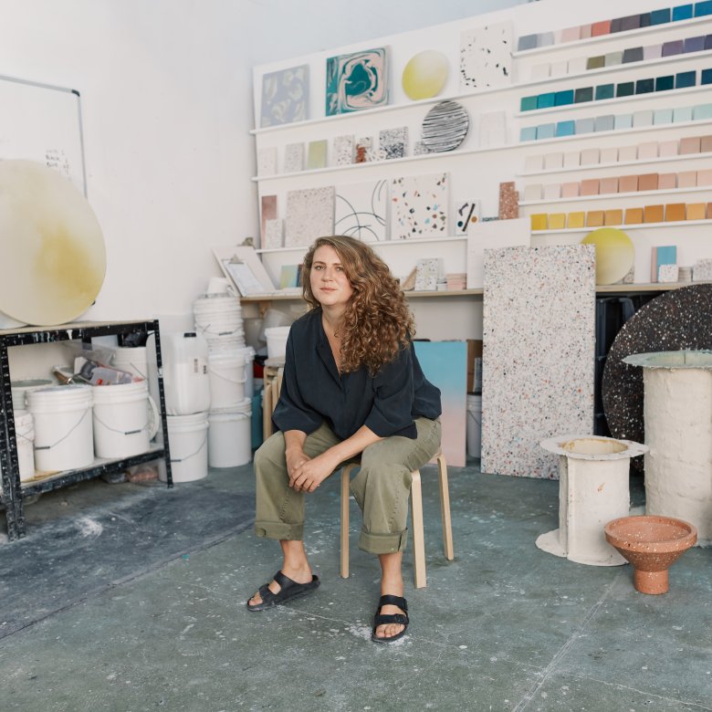 A woman sat on a chair in her studio