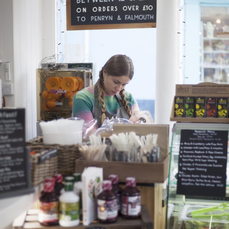 Girl with long hair working behind a counter in a shop