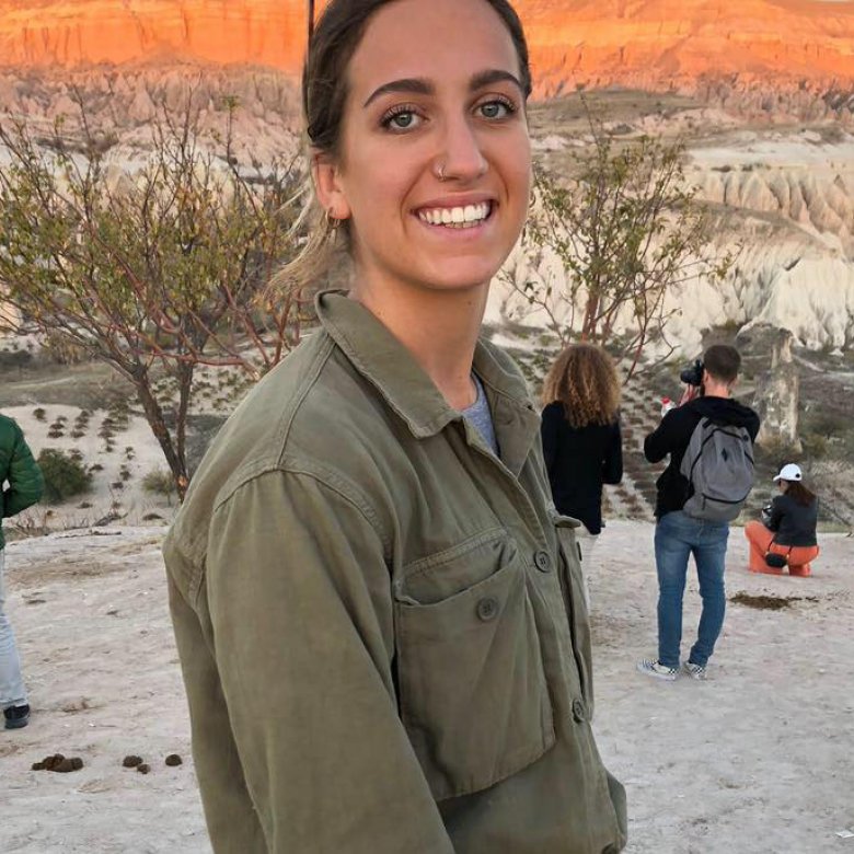 A woman smiling, wearing a green shirt