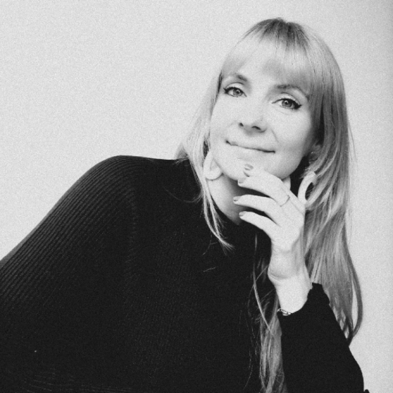 A woman looking into the camera smiling