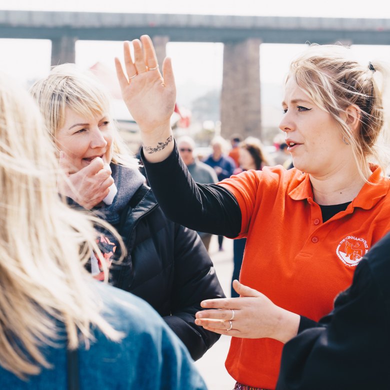 An event steward giving people directions