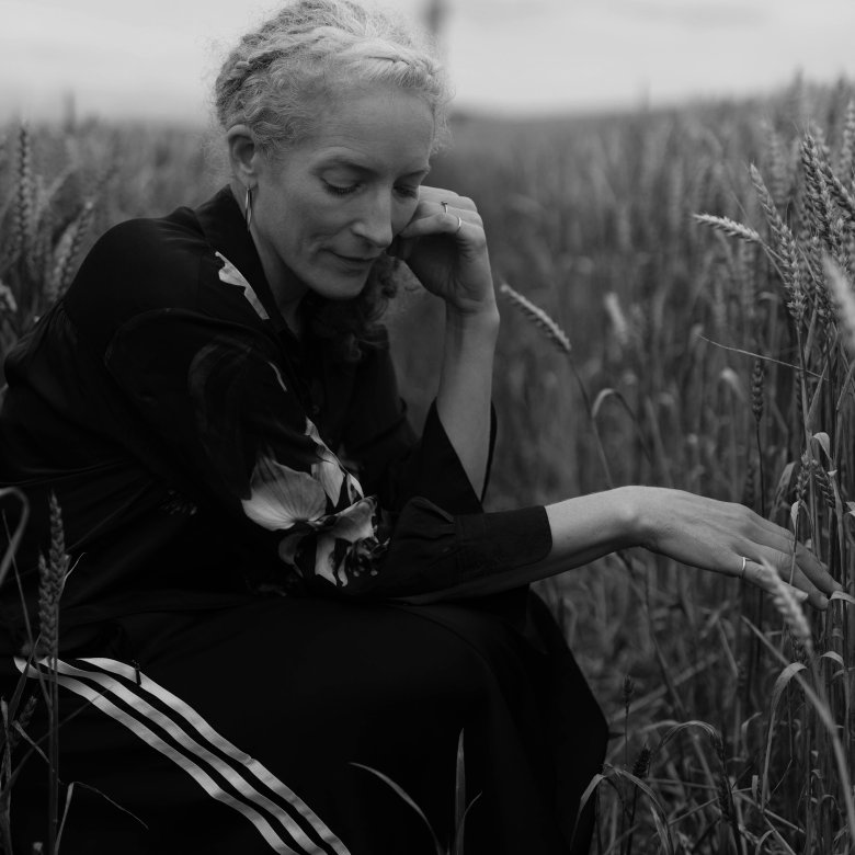 A woman sat in a field