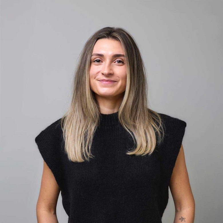 A woman smiling into the camera