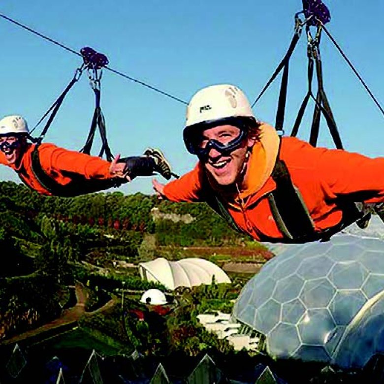 Two people on a zip line above The Eden Project