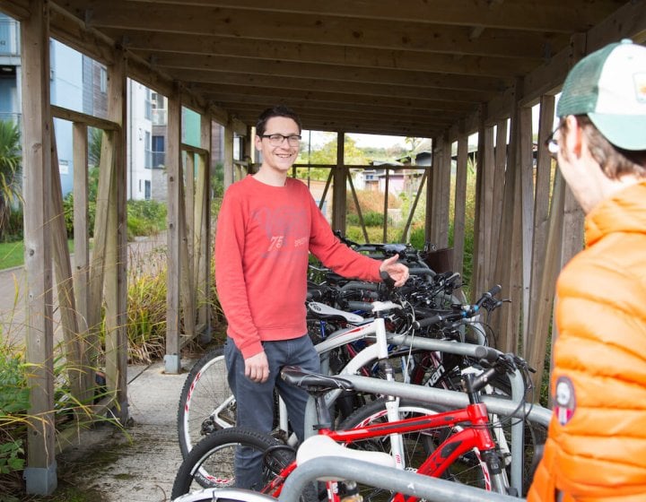 Students chatting in bike store on Penryn Campus