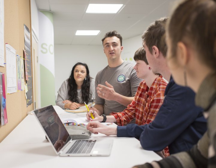 Falmouth University Entrepreneurship students in the studio with a laptop