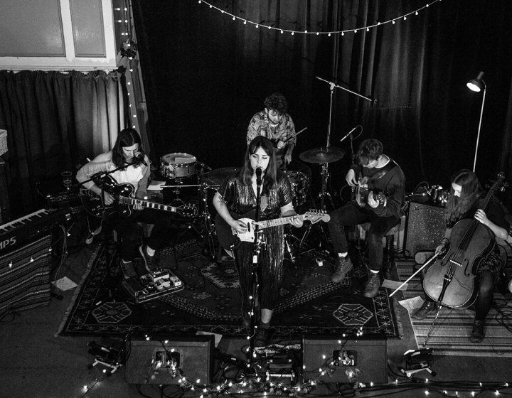 Music students playing instruments in a band with fairy lights
