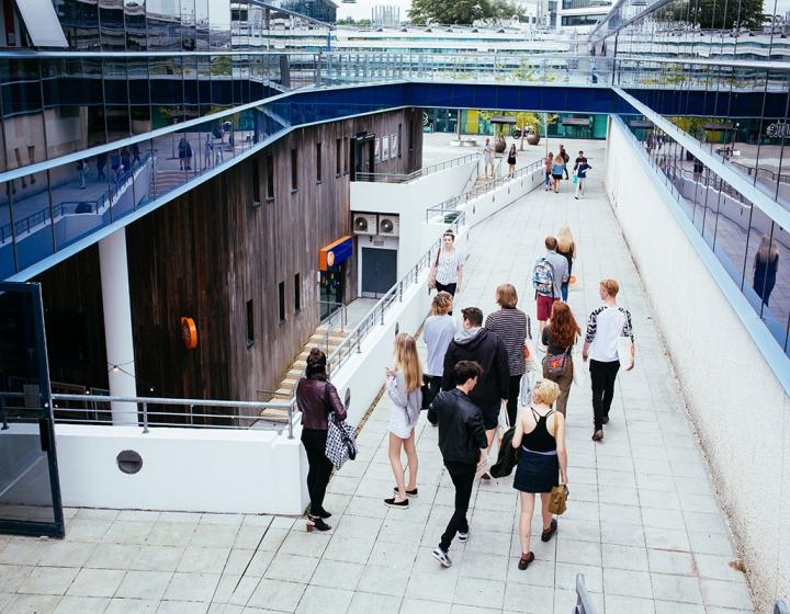 Group of students on walkway at Penryn campus.