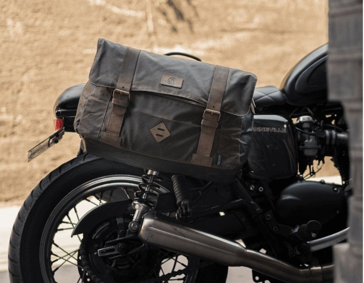 a leather bag strapped to the side of a motorbike