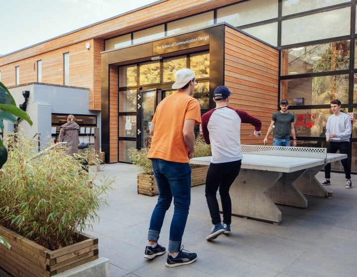 Students playing table tennis on Falmouth campus.