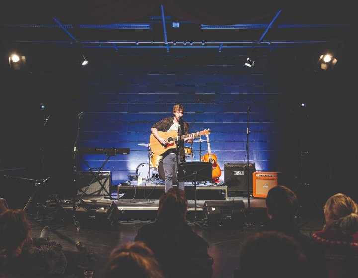 A guitarist performs on stage