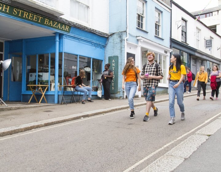 Three students walking down Falmouth high street