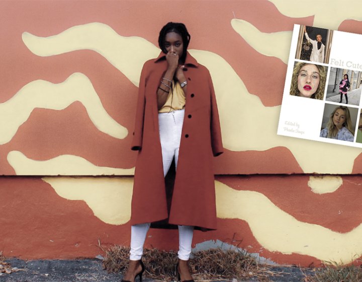 A woman in a red coat in front of a yellow and red wall