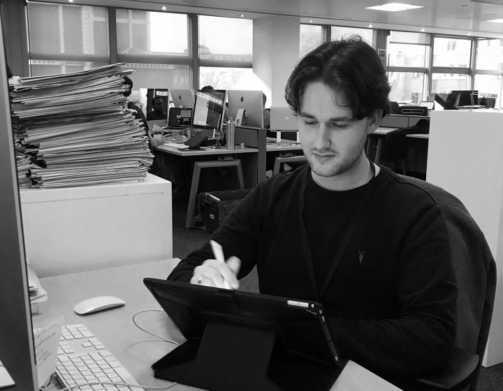 Illustration graduate Jake Hawkins at his desk