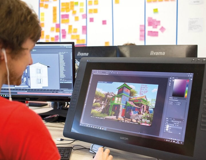 Games student working on digital game artwork on a screen.