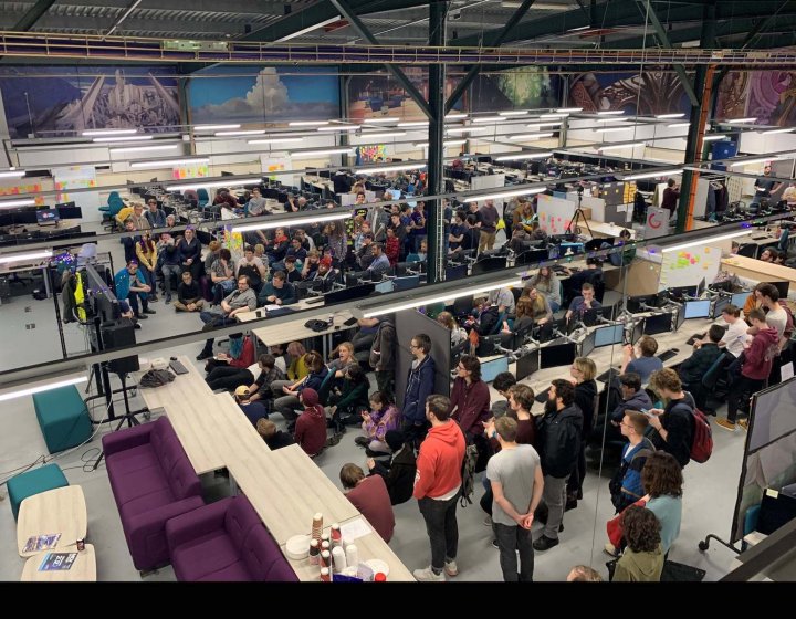 A crowd of students in the Games Academy with computers