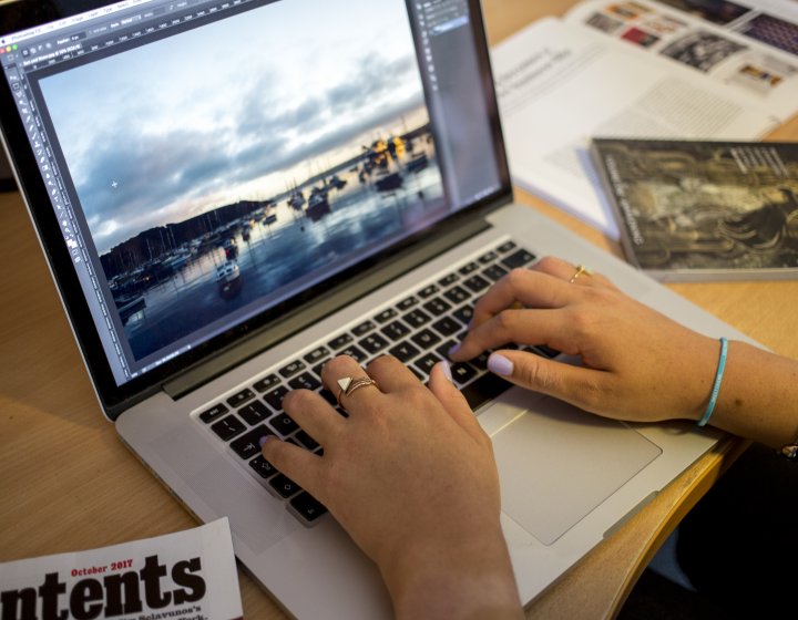 Student studying at laptop and desk