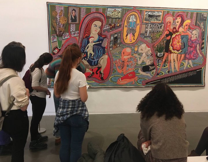 Falmouth University Illustration students looking at a large tapestry by artist, Grayson Perry