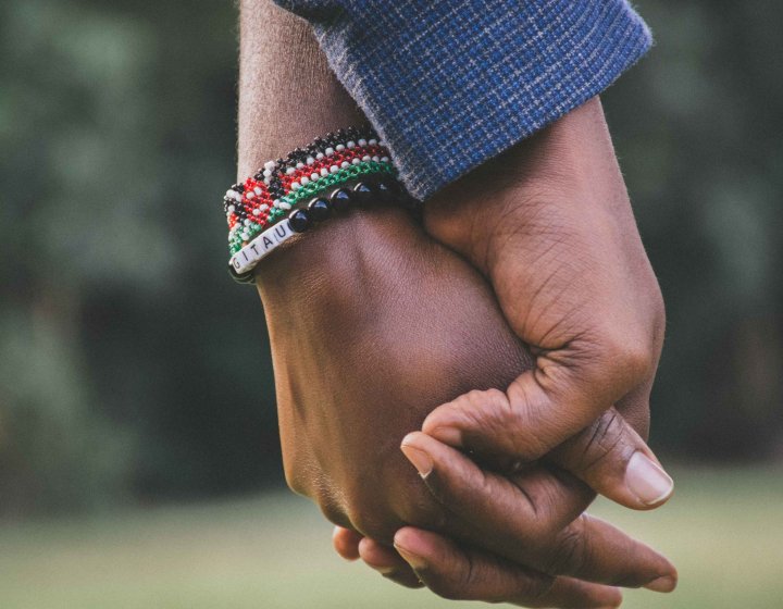 A close up image of hands being held 