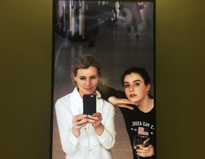 Two Falmouth University students taking a photo of themselves in a mirror