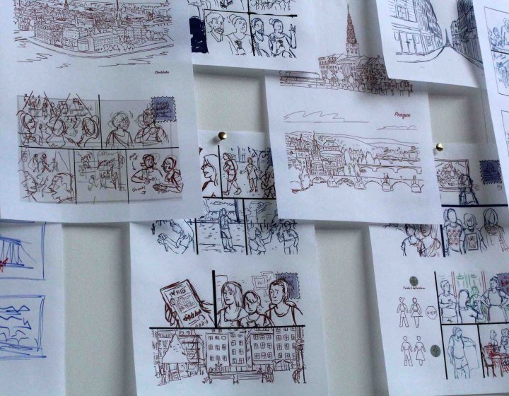 A selection of drawings on paper pinned to a wall