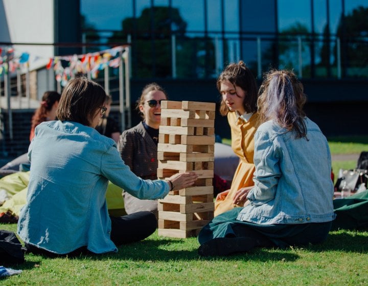 Falmouth international students playing giant Jenga outside.