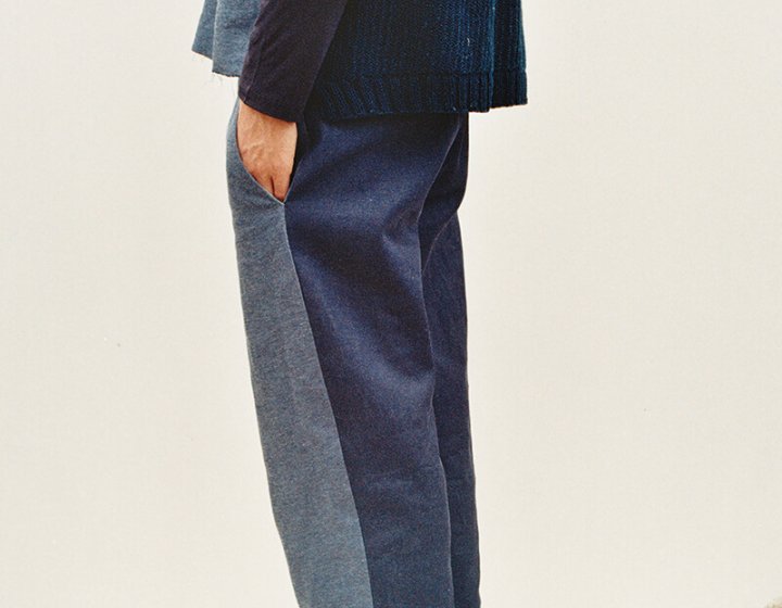 Head cropped model wearing two toned blue suit and black shoes