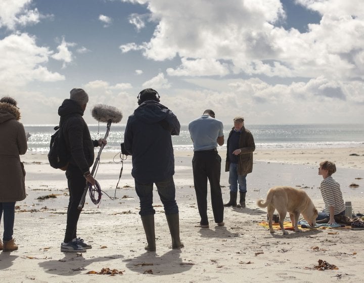 Falmouth University student film crew on beach location.