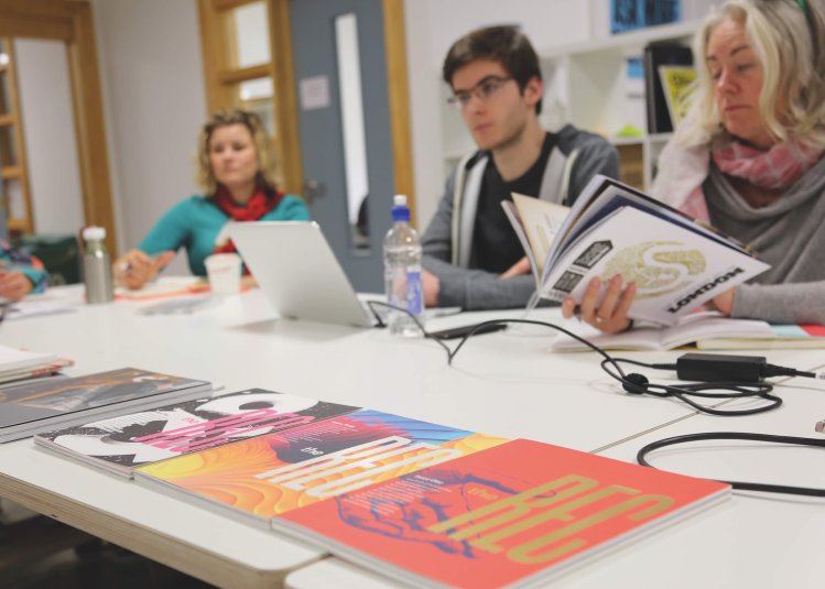 Falmouth University MA Graphic Design students at a table