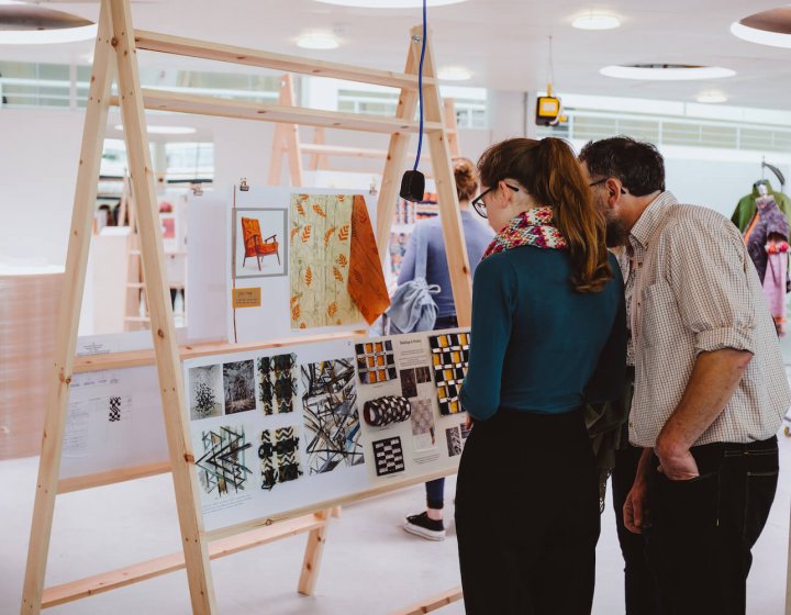 A father and daughter looking at an art exhibition at Falmouth University