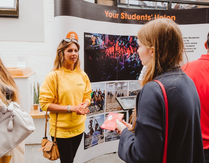 Open day ambassador talking to prospective student.