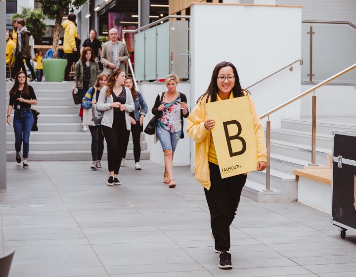 Student ambassador leading group down steps